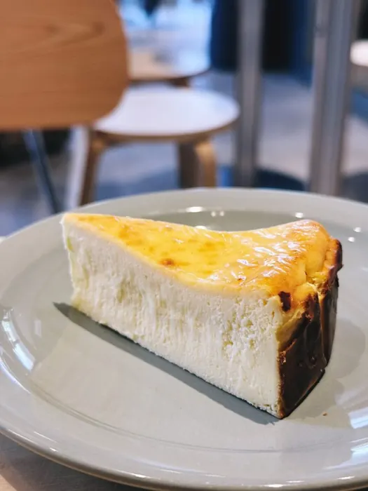Slice of Basque cheesecake on a grey plate