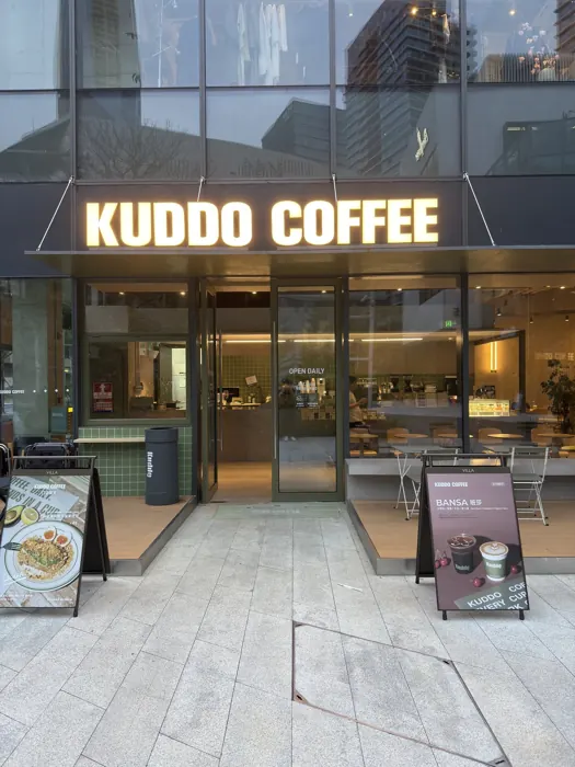 Kuddo Coffee front entrance and glowing sign